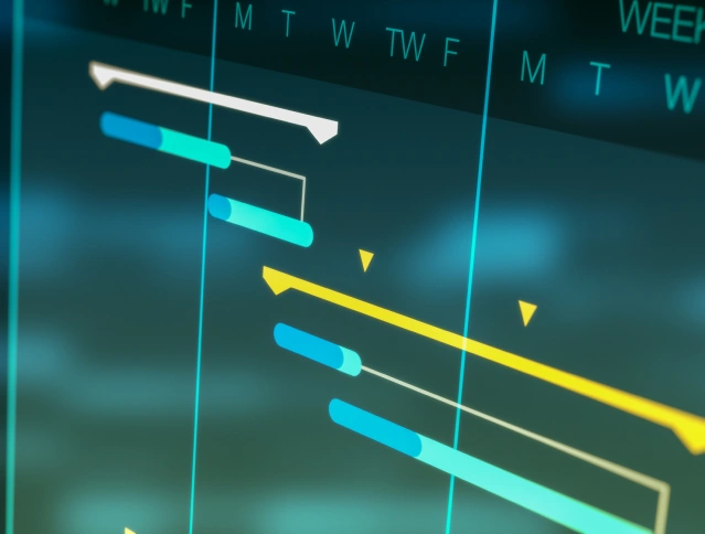 A digital diagram showing a Gantt chart with horizontal bars in blue, green, and yellow representing tasks across a weekly timeline. Triangular markers indicate specific points on the timeline. The background is blurred.