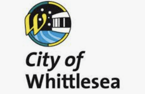 Logo for the City of Whittlesea featuring a stylized "W," stars, a building, and blue waves above the text "City of Whittlesea" on a white background.
